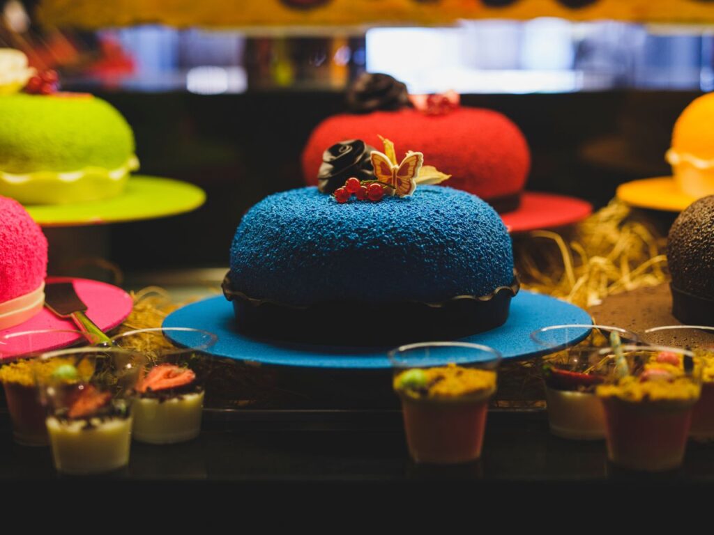 Vibrant display of assorted colorful cakes and desserts, perfect for celebrations.